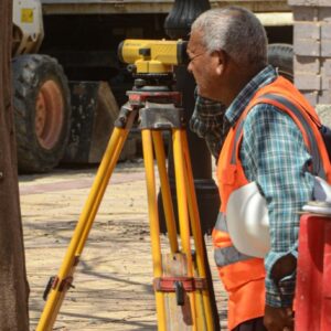 Topógrafo trabajando con una estación total sobre trípode